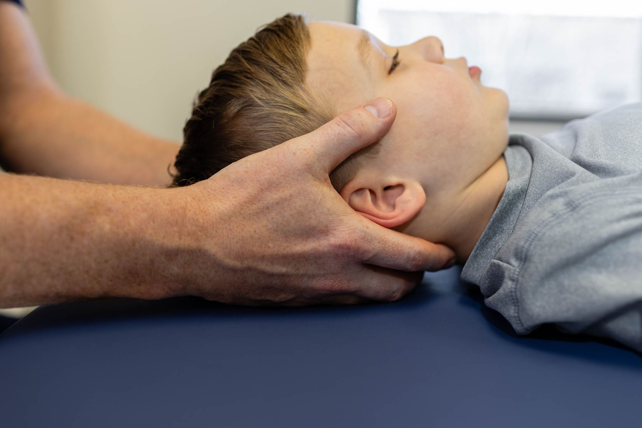 A person is holding their head in the air