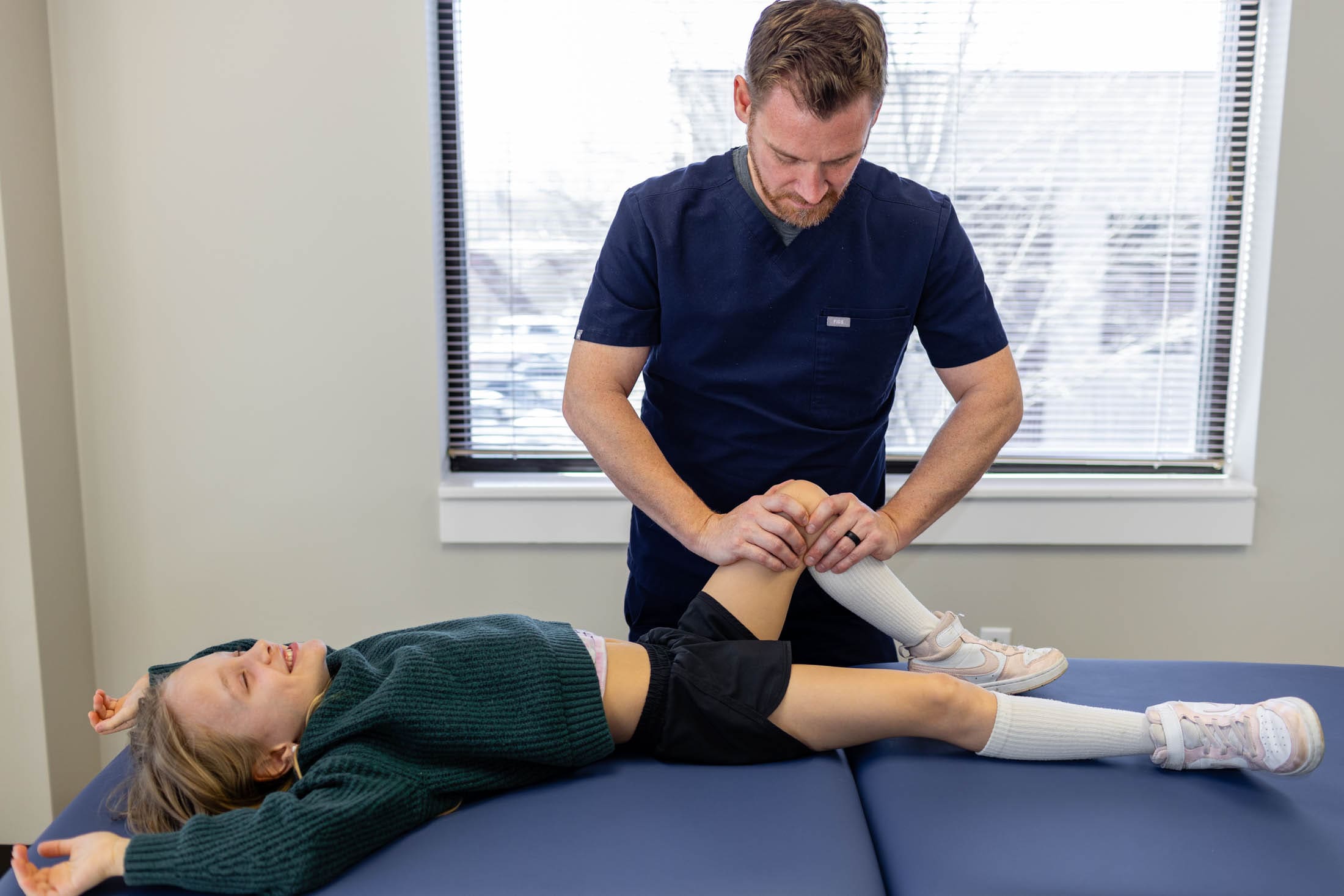 Therapist performing knee mobilization on child